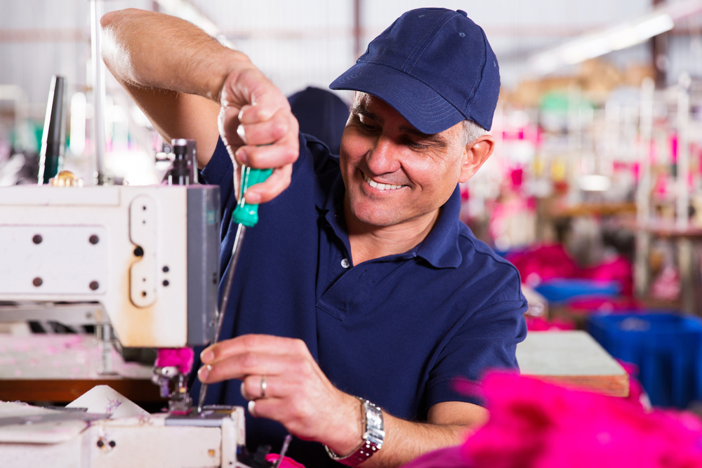 Sewing machine repairman fixing a sewing machine